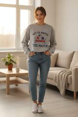 Gray sweatshirt with a graphic of a character in a cat hat and text 'Just one more episode' on a white background