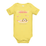 Yellow baby onesie with cartoon design and text on a white background