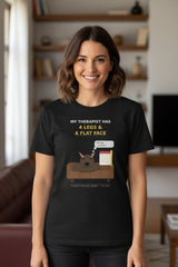 Black t-shirt with a graphic of a dog on a couch and text about a therapist with 4 legs and a flat face.