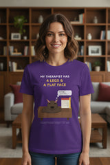 Purple t-shirt with a graphic of a dog on a couch and text about a therapist, on a white background.