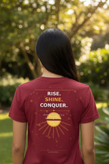 mahroon t-shirt with a sunset and palm tree design on the front, displayed on a white background.
